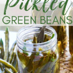 A quart glass jar with fresh green beans and ingredients inside the open jar after pickling the green beans.