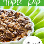 A dessert dip recipe for caramel apple dip with the dip in a white flower shaped low dish, and green apple slices around the dish.