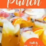 3 tall glasses of orange colored fall cocktail party punch with orange slices asa garnish, and a large punch bowl in the background full of punch garnished with apples, oranges, and cinnamon sticks.