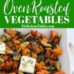 Oven roasted vegetables in a white casserole dish including butternut squash, carrots, Brussel sprouts, and sweet potato.