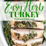 A whole roasted herb turkey breast roast in a white casserole dish surrounded with fresh herbs.