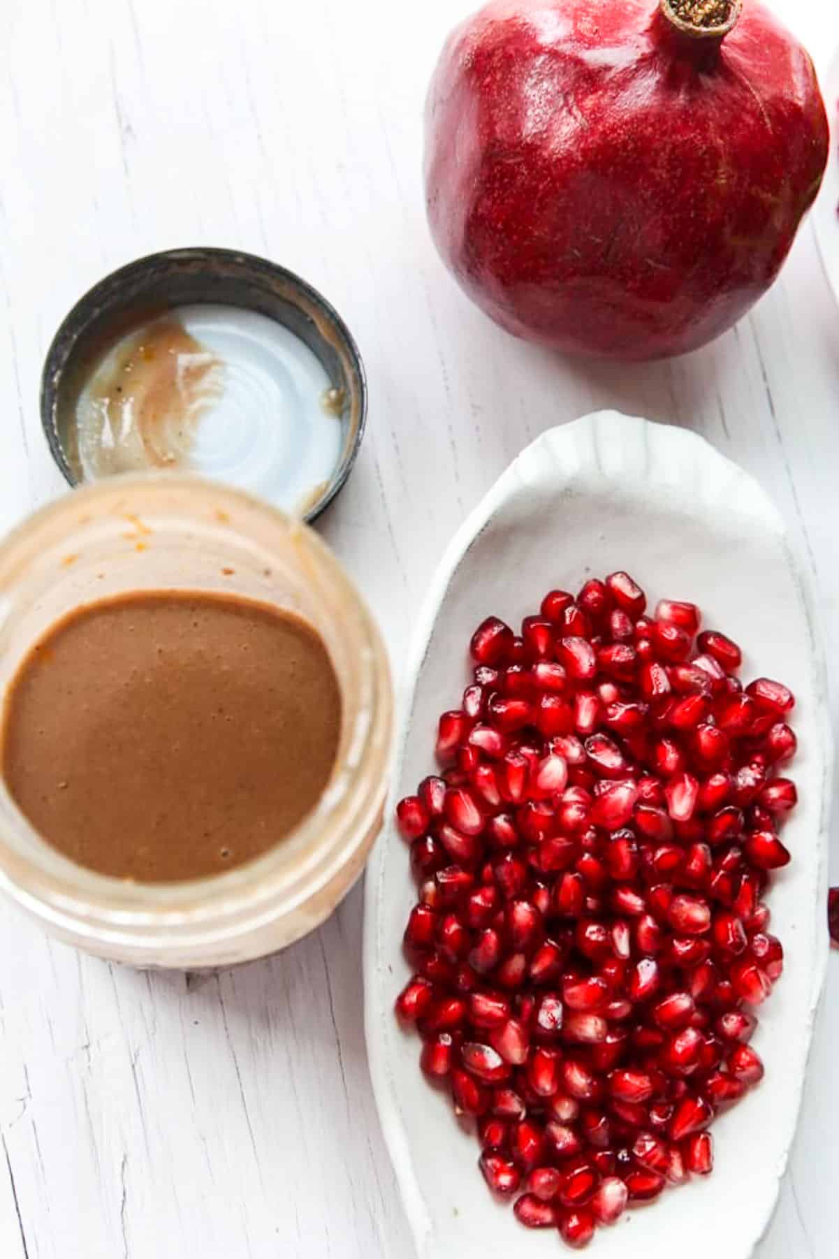 This image has an empty alt attribute; its file name is Making-pomegranate-Mason-jar-dressing.jpg