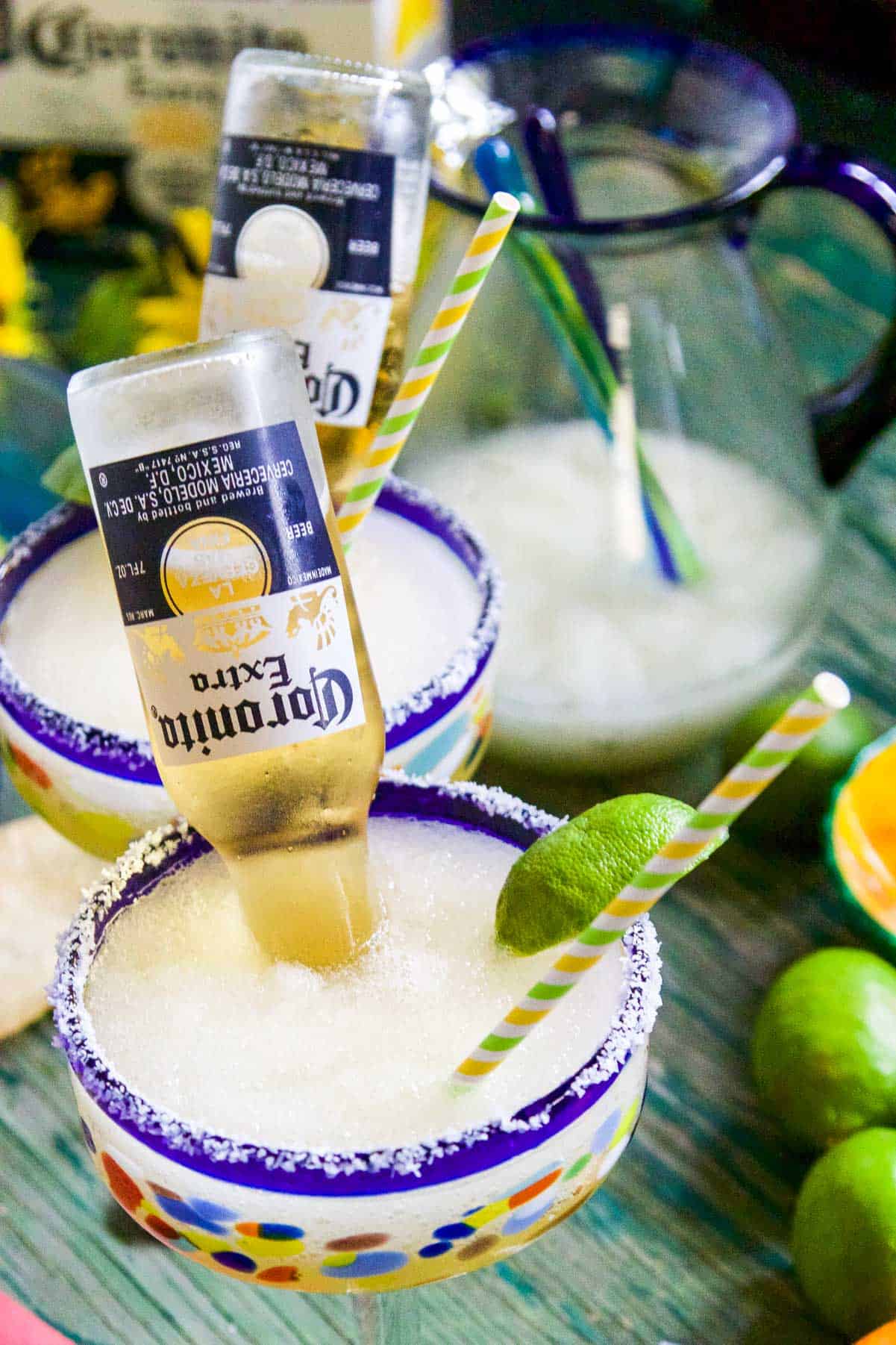 Two glasses of frozen margaritas made into CoronaRitas with Coronita beers poured inside.