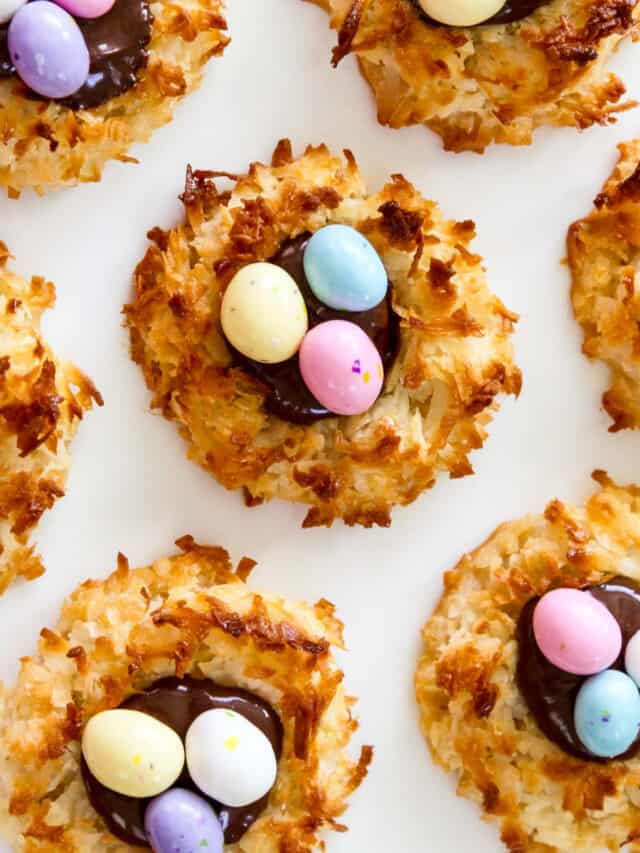 An overhead view of fresh baked and decorated Easter dessert coconut macaroon cookies.