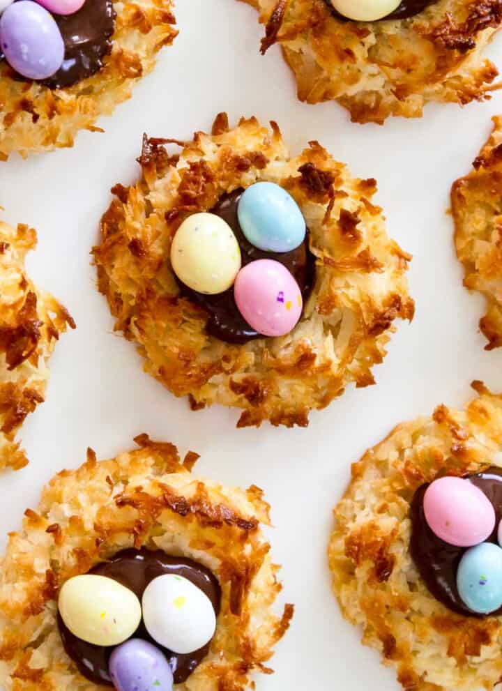 An overhead view of fresh baked and decorated Easter dessert coconut macaroon cookies.