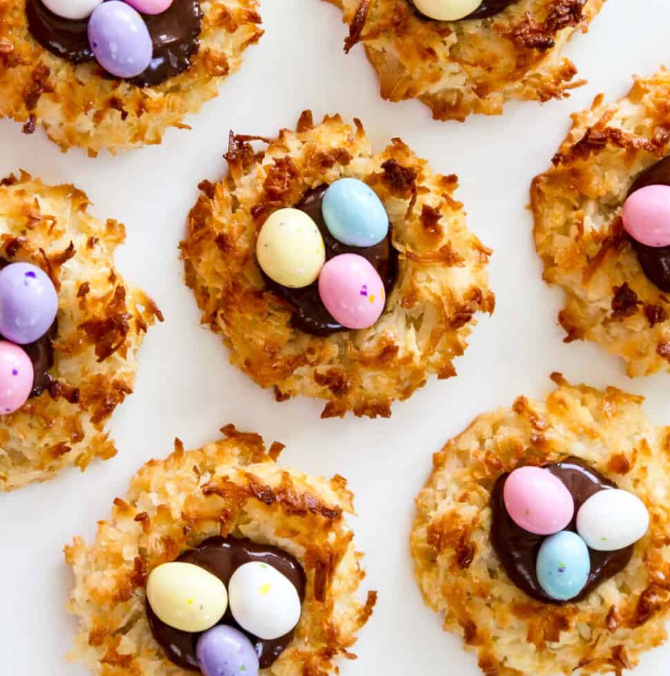 An overhead view of fresh baked and decorated Easter dessert coconut macaroon cookies.