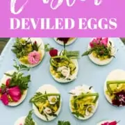 An ad for Easter deviled eggs showing them on a blue platter decorated with garden herbs and edible flowers.