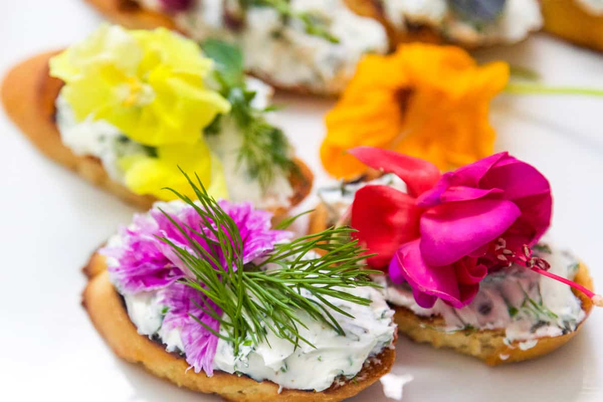 Crostini topped with Cream Cheese Spread and edible flowers.