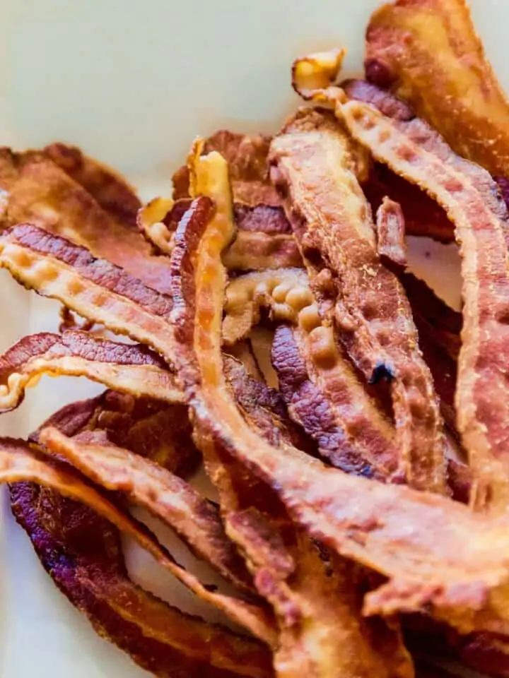 A pile of strips of crisp bacon in a pile to use in a recipe.
