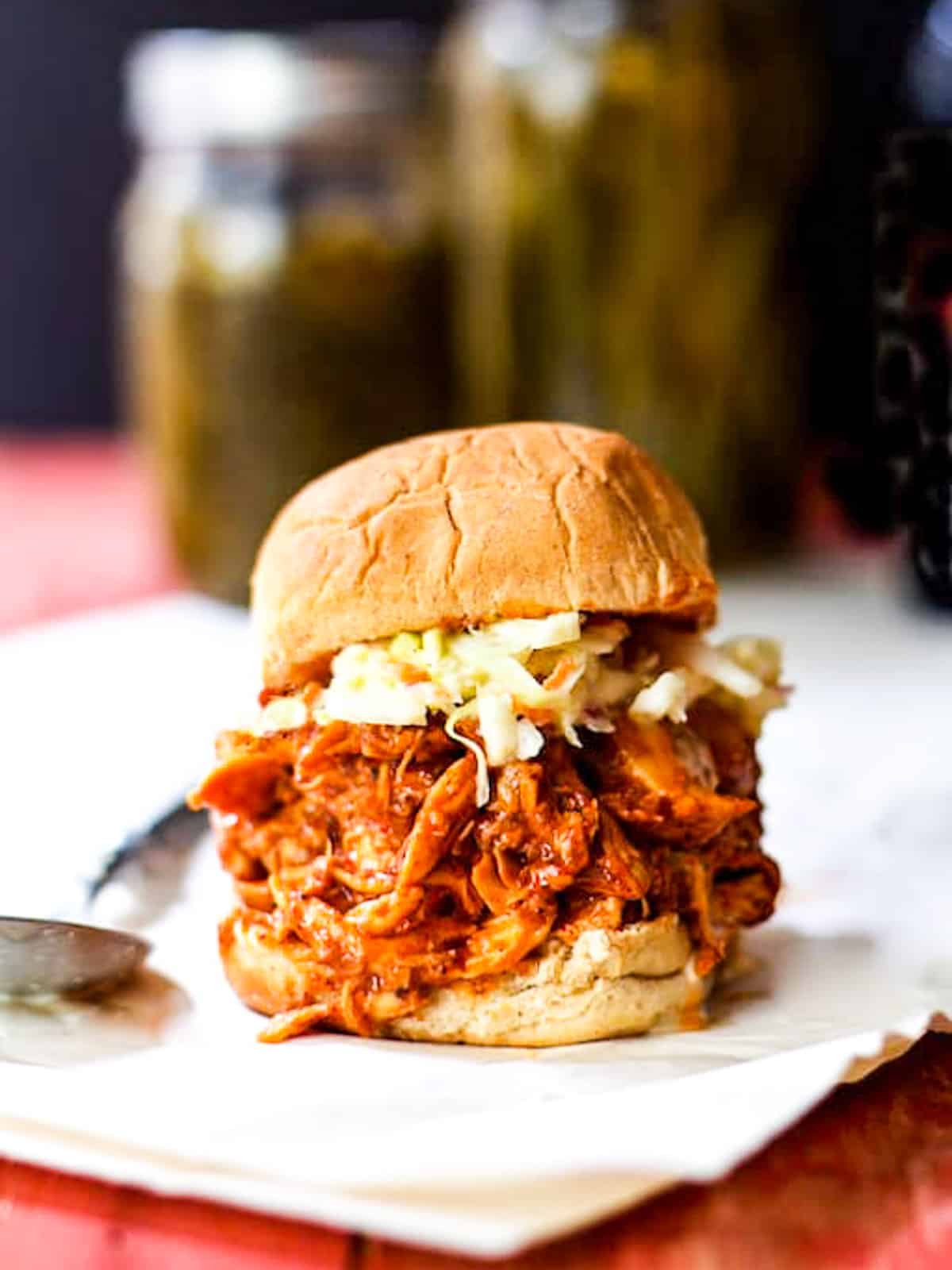 A pulled chicken sandwich on a hamburger bun.