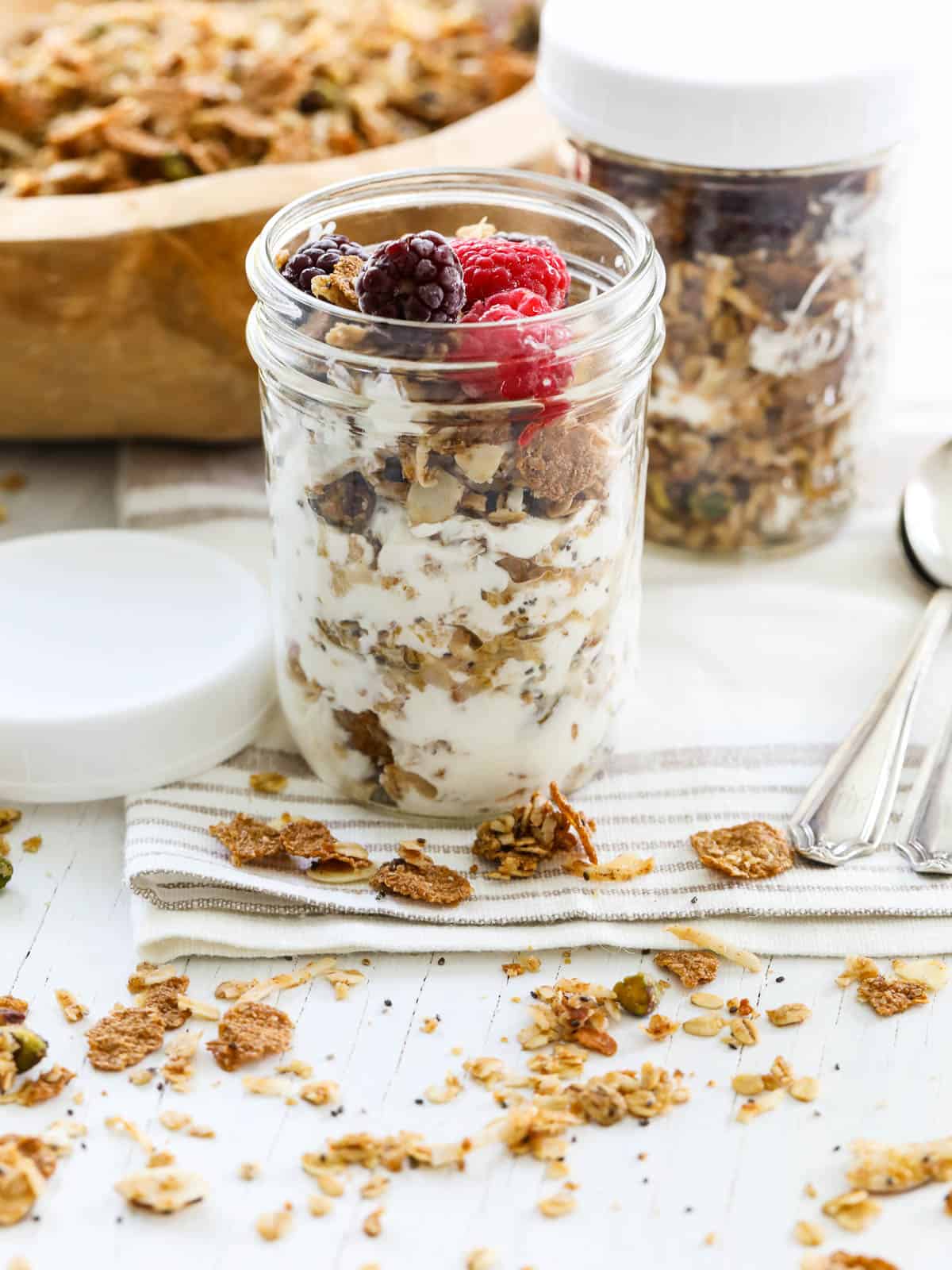 A layered yogurt parfait with granola and fresh raspberries and blackberries.