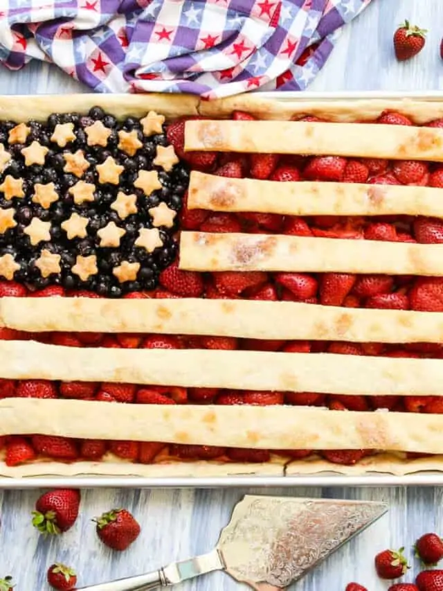 A sheet pan filled with a flag pie made with strawberries, blueberries, and pie crust.