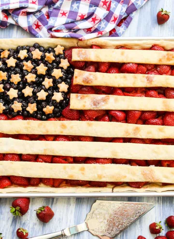 A sheet pan filled with a flag pie made with strawberries, blueberries, and pie crust.