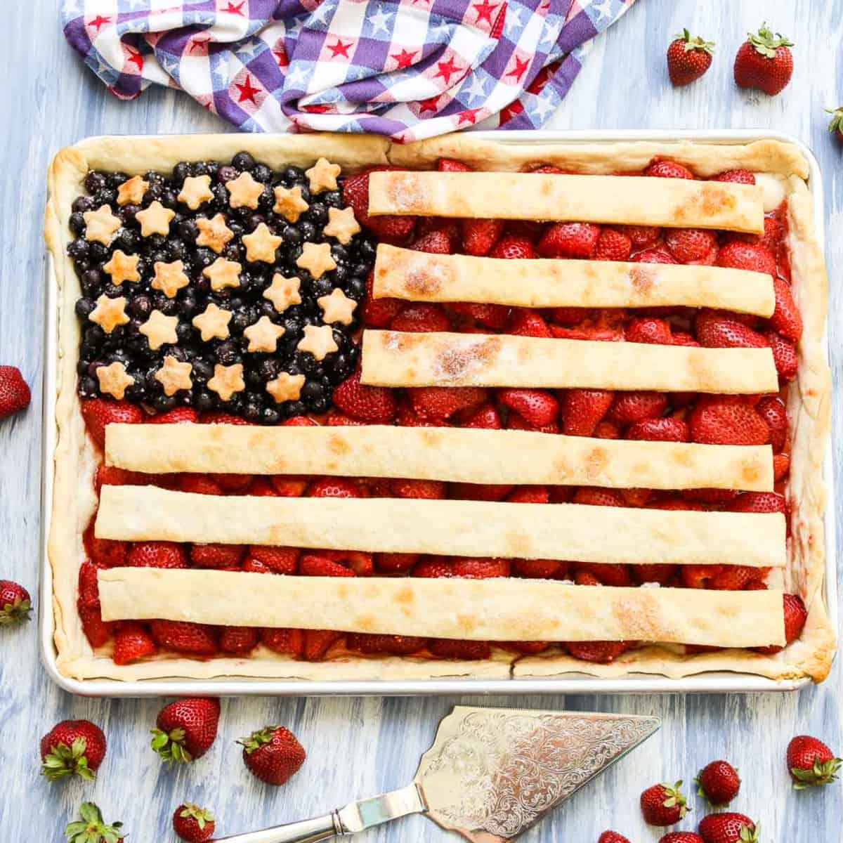 A sheet pan filled with a flag pie made with strawberries, blueberries, and pie crust.