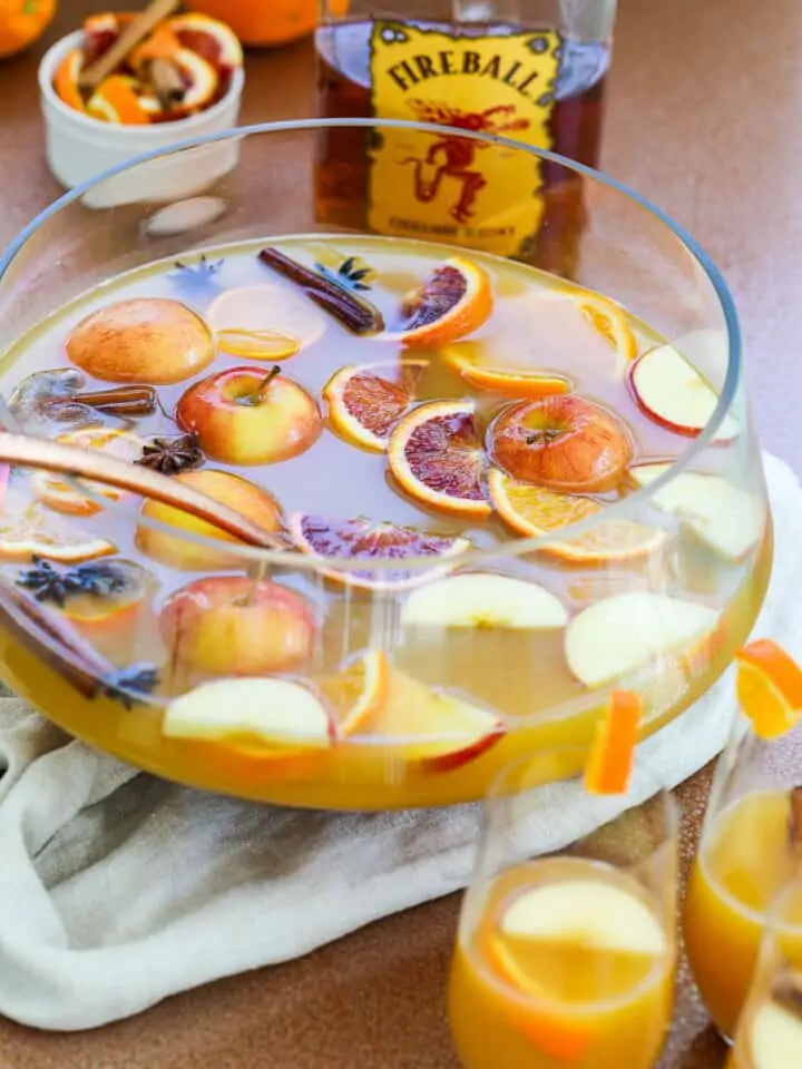 A large bowl of Fireball punch made with orange juice, Fireball whisky, apple cider to serve as a Thanksgiving cocktail.