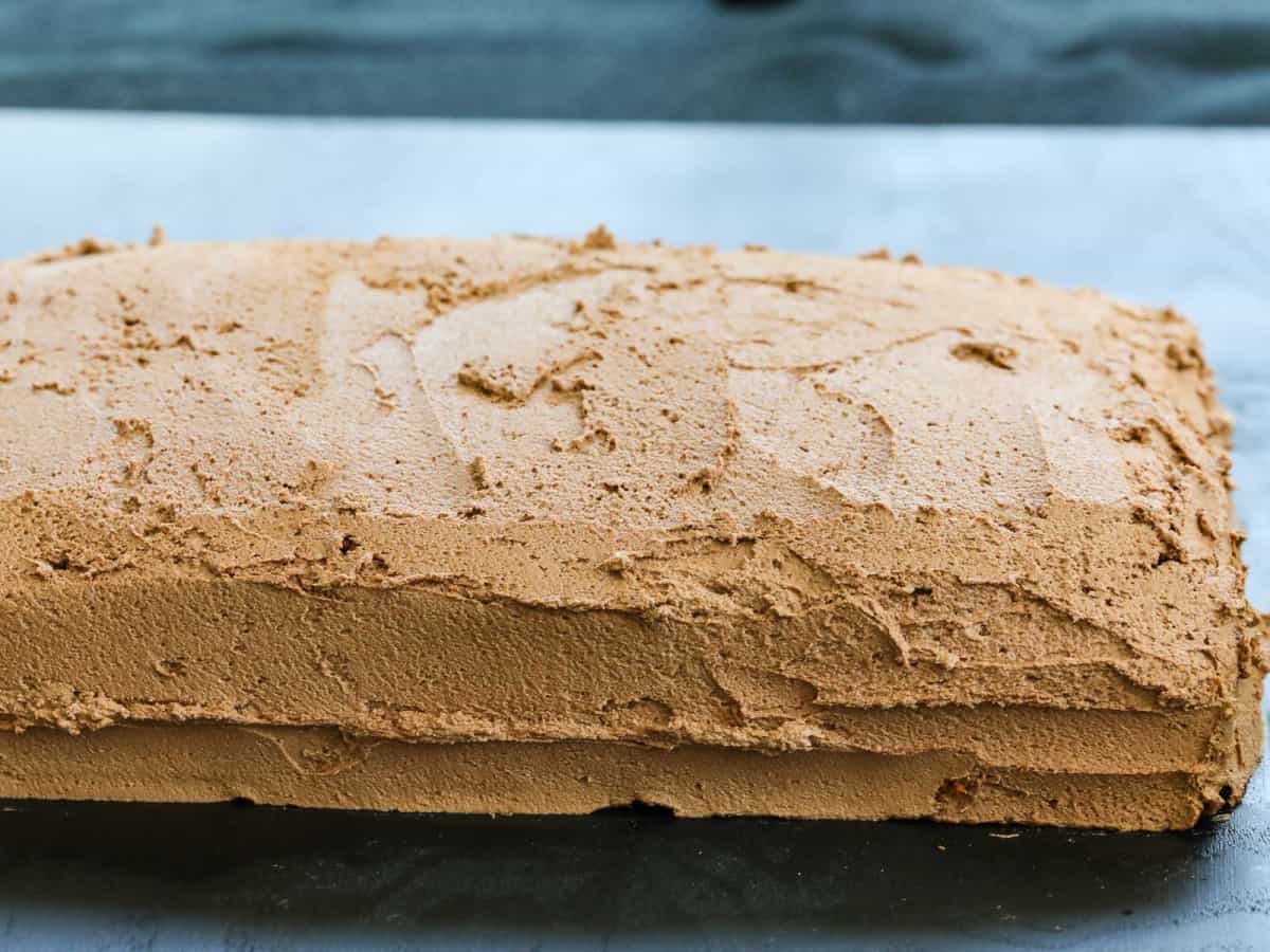 A 9 x 13 chocolate sheet cake frosted on a table.