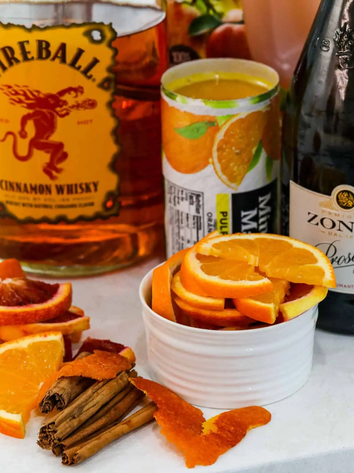 Ingredients to make Fireball punch; orange juice concentrate, Prosecco, Fireball Whisky, and apple cider.