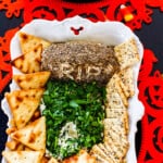 A tombstone shaped Halloween dip served with crackers.