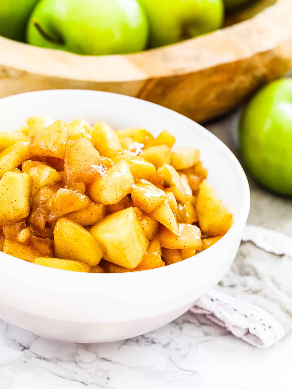 Cooked apple pie filling in a bowl ready to make pies.