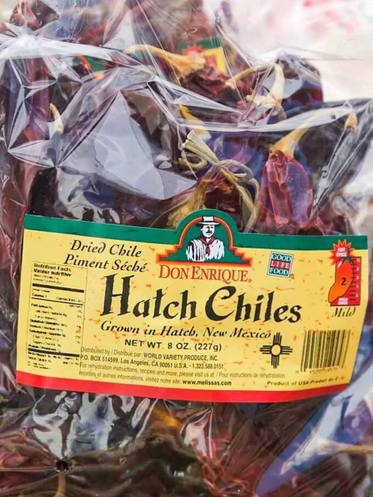 A clear cellophane bag filled with dried red Hatch chiles to use in recipes. 