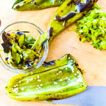 Showing how to remove seeds from roasted Hatch Chiles to use them in recipes.