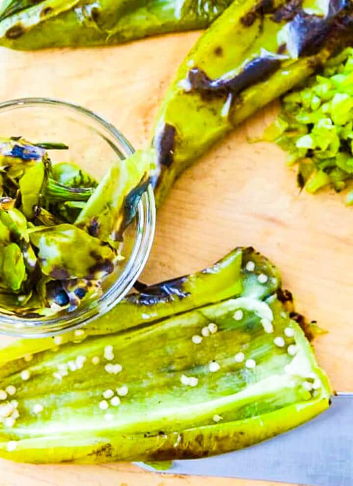 Showing how to remove seeds from roasted Hatch Chiles to use them in recipes.