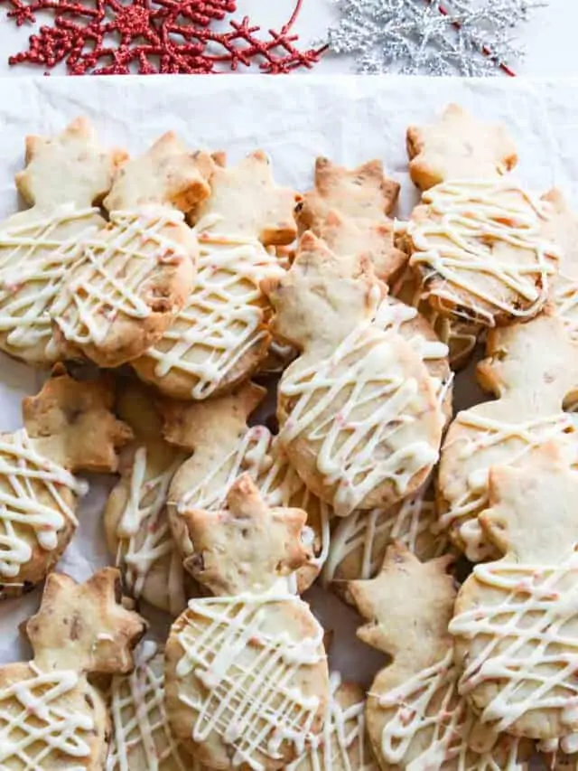 A pile of pineapple shaped peppermint macadamia nut shortbread cookies.