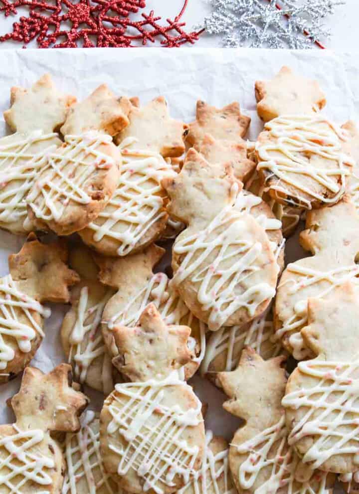 A pile of pineapple shaped peppermint macadamia nut shortbread cookies.