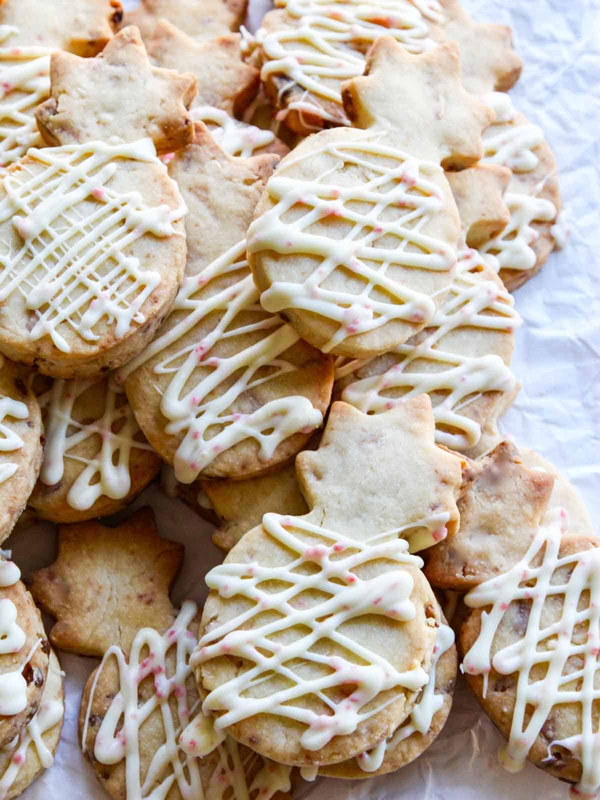 A plate of peppermint icing drizzled shortbread Christmas cookies.