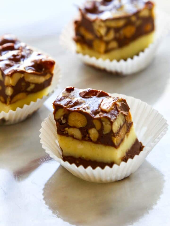 Cut pieces of Nut Goodie Bar Candy in white paper cups.