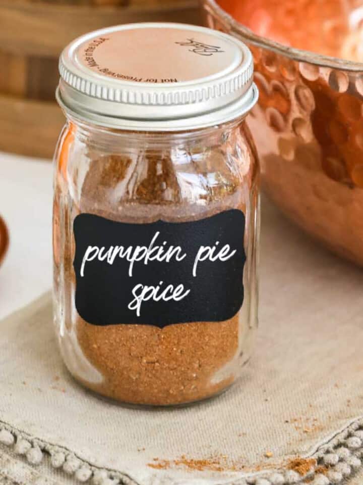 A small glass spice jar filled with pumpkin pie spice made at home.