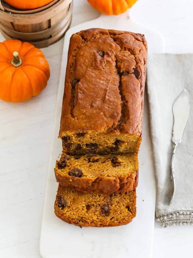 A fresh baked loaf of pumpkin bread cut into thick slices.