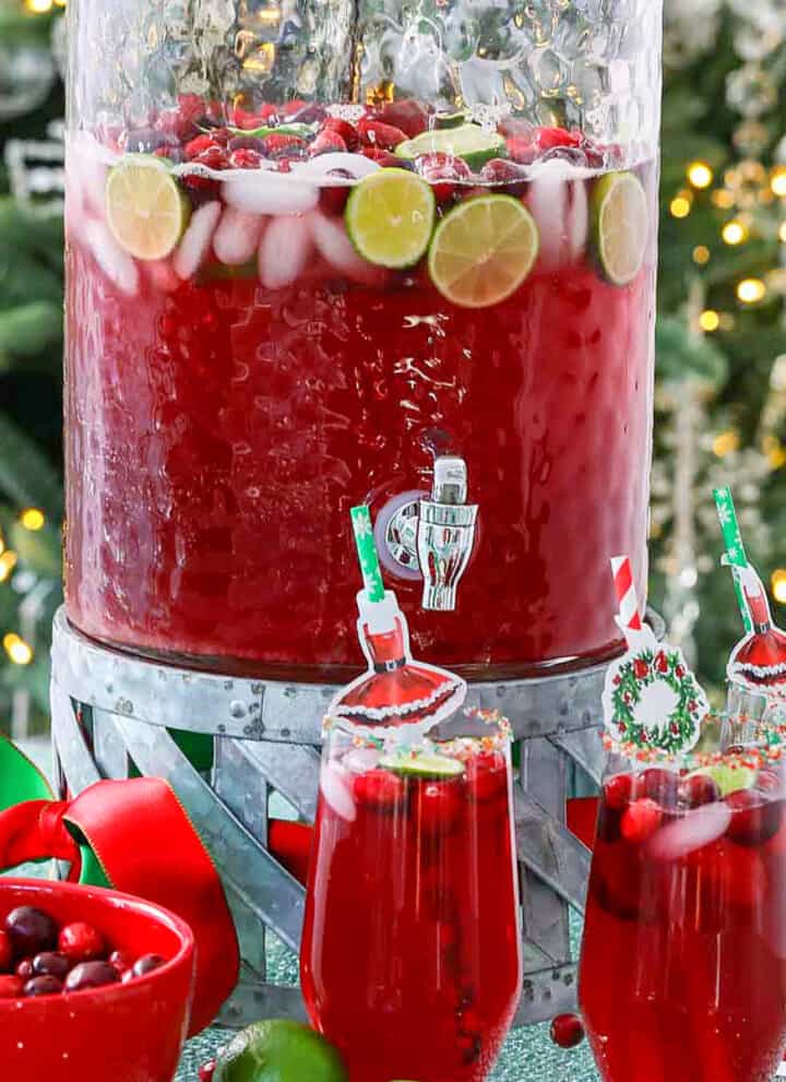 A big glass beverage container filled with holiday Christmas Punch.