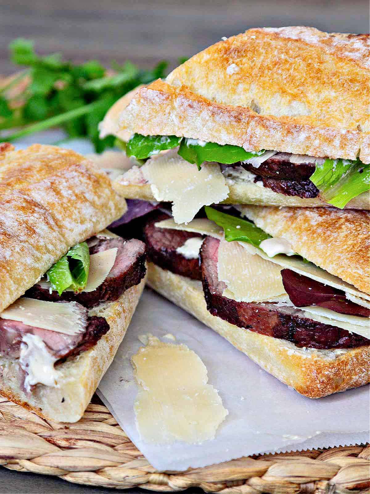 Shaved parmesan on roast beef sandwiches on baguettes.