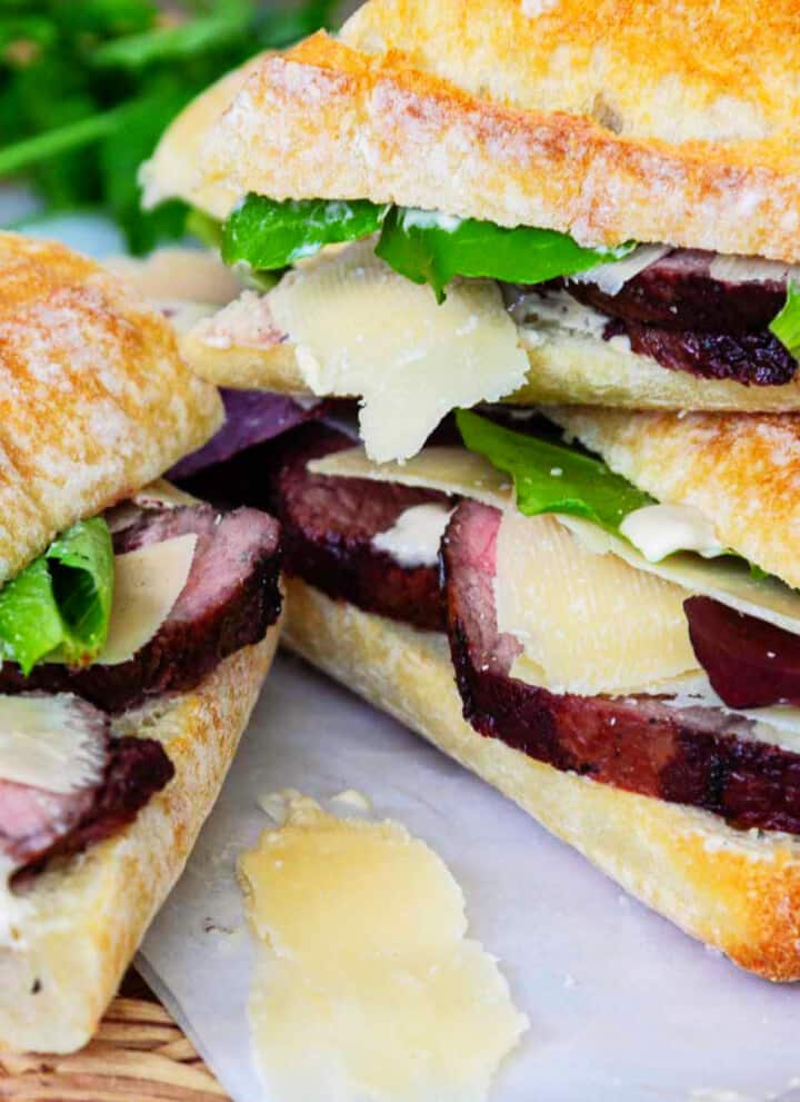 Thick sliced roast beef on baguettes with lettuce, horseradish sauce, and shaved parmesan.