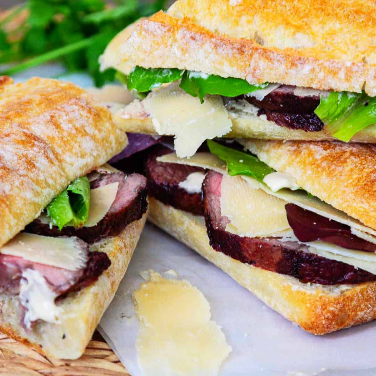 Thick sliced roast beef on baguettes with lettuce, horseradish sauce, and shaved parmesan.