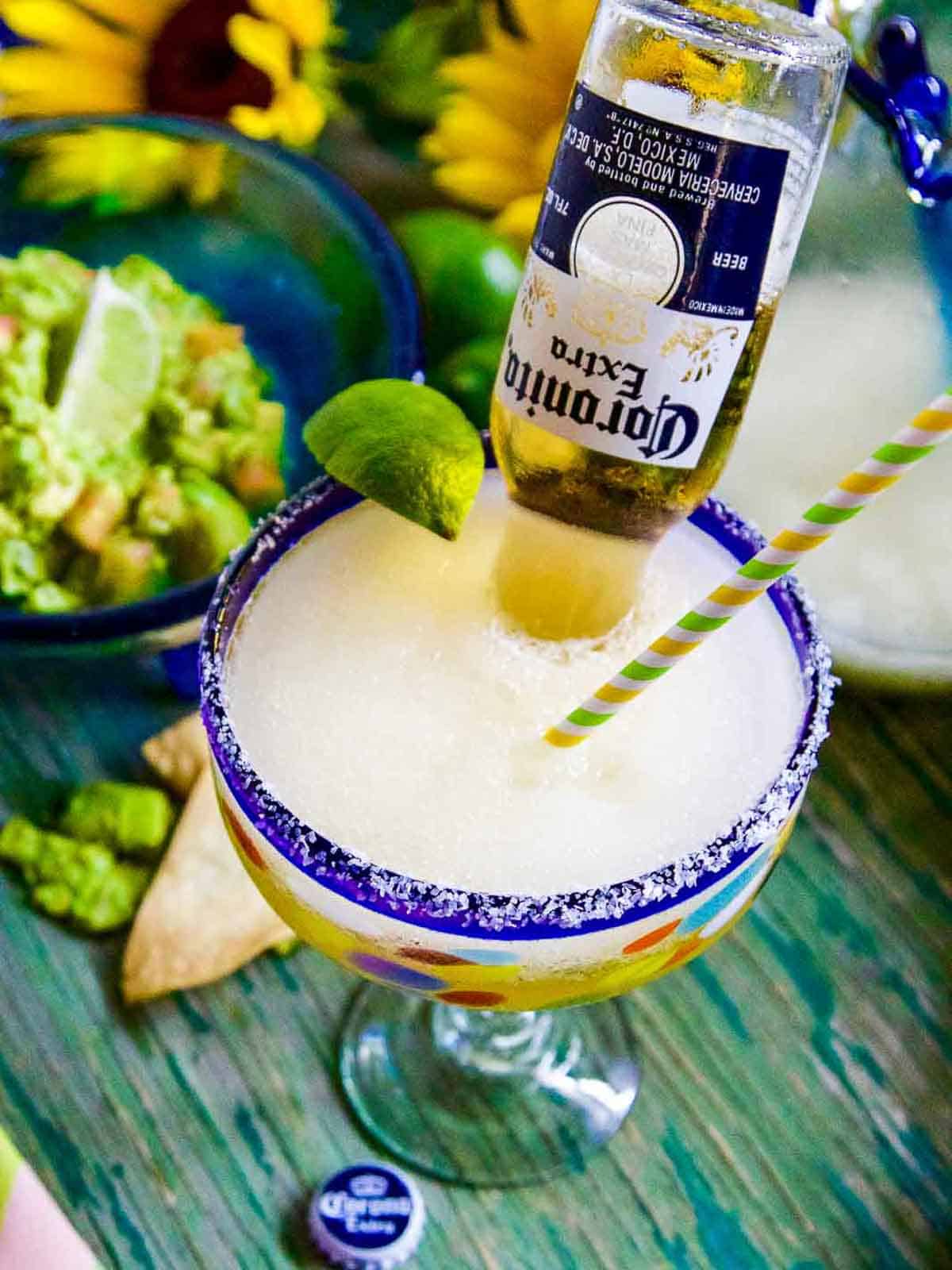 A CoronaRita margarita served at a party with guacamole and chips