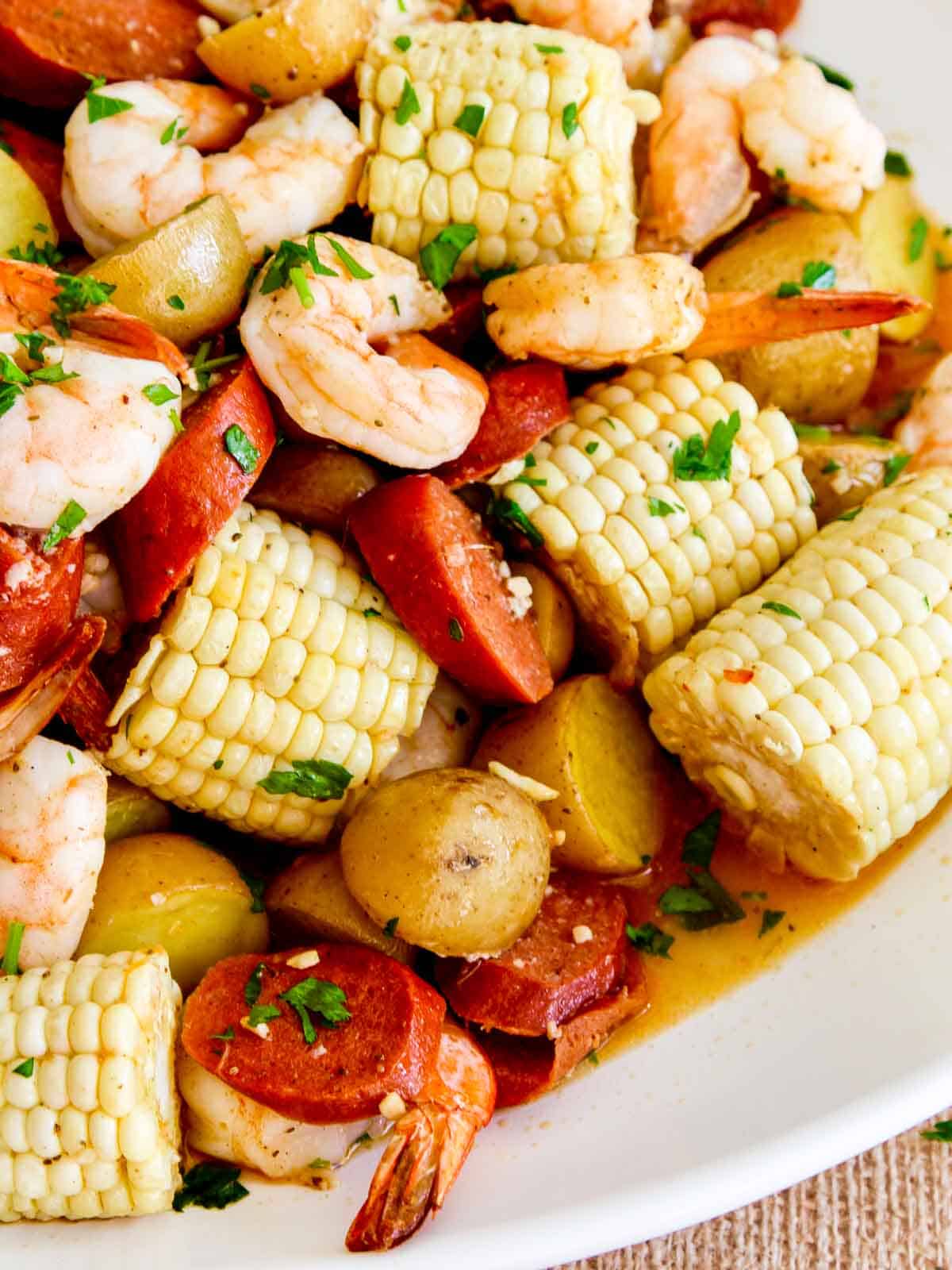 A white platter filled with a shrimp boil recipe for dinner. 