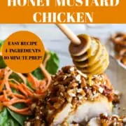 A piece of baked chicken drizzled with honey mustard and a side salad for a honey mustard chicken recipe.