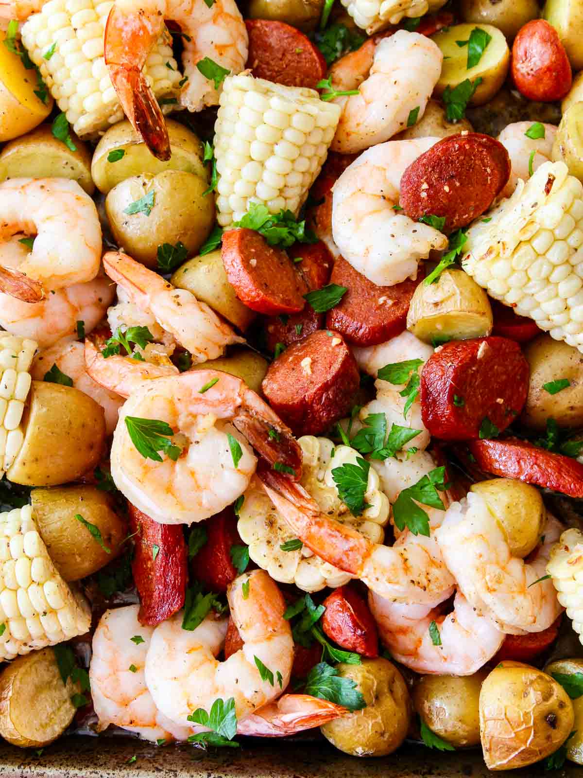 Cooked shrimp, potatoes, slices of andouille sausages and pieces of corn ready to eat for dinner. 