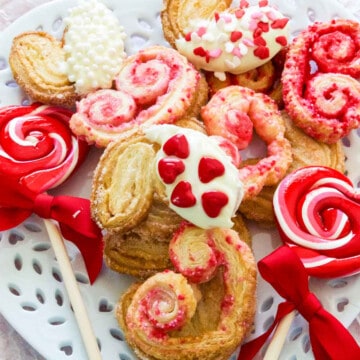 A white plate with heart shaped colorful Valentine cookies.