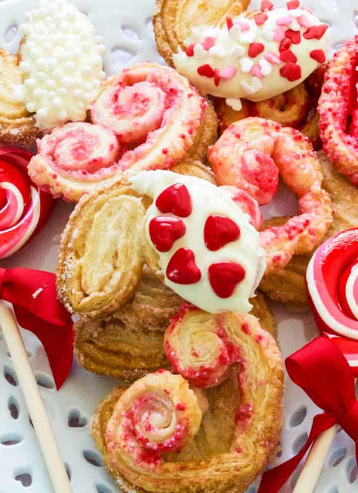 A white plate with heart shaped colorful Valentine cookies.