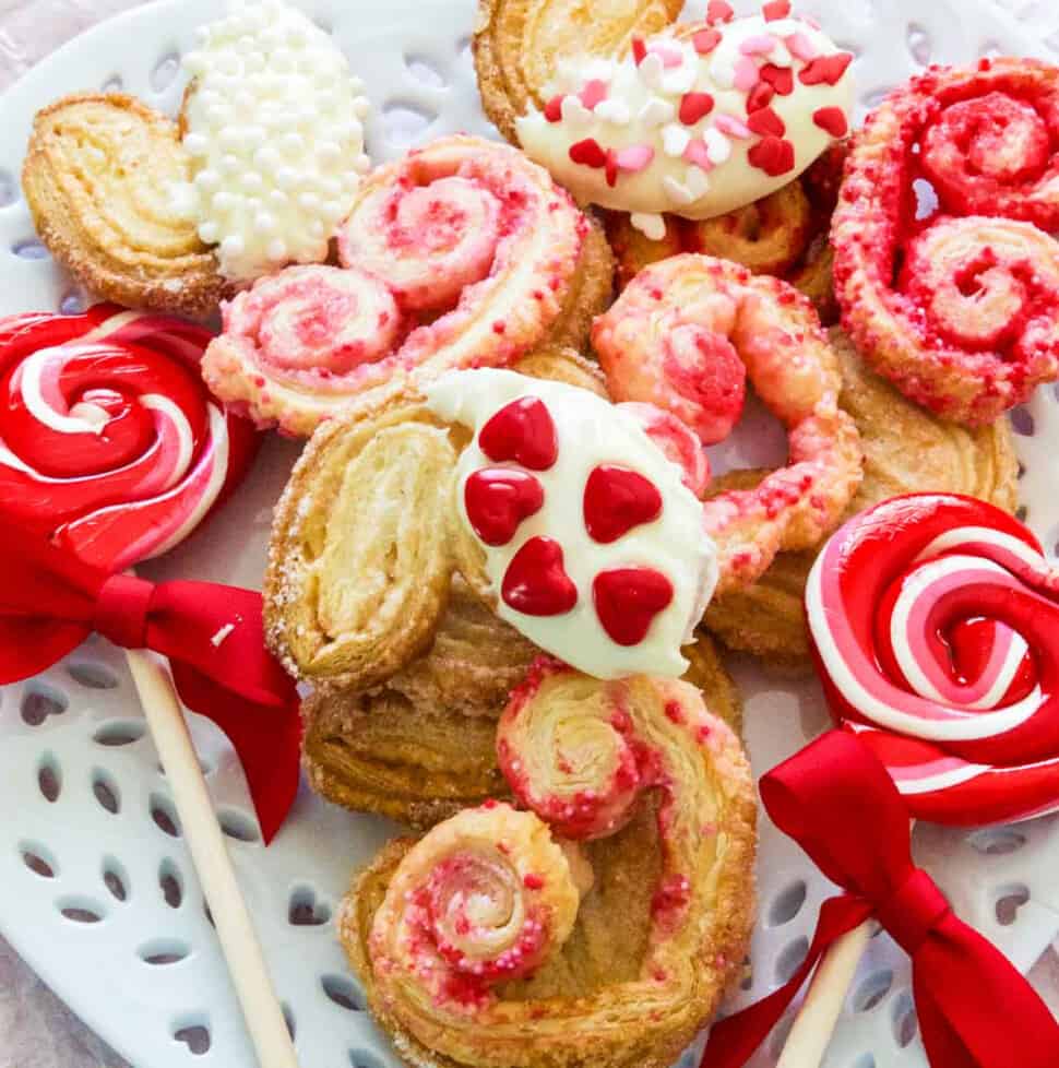 A white plate with heart shaped colorful Valentine cookies.