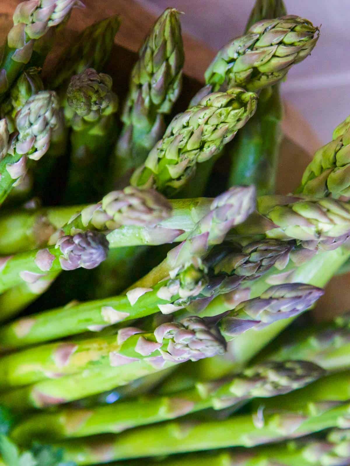 Fresh bright beautiful asparagus in a pile ready to use in a recipe.