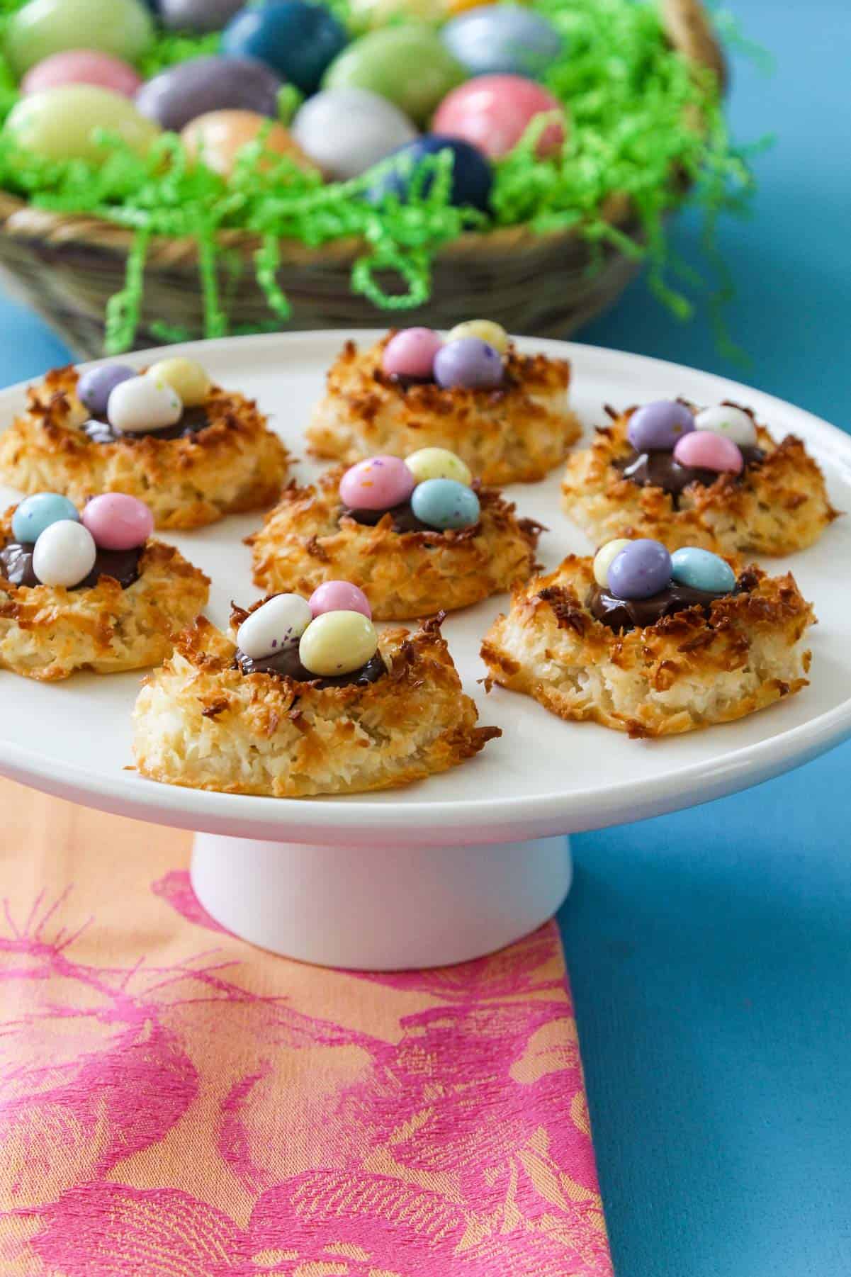 A great recipe for Easter dinner white cake plate with bird nest coconut marcaroons with candy eggs.