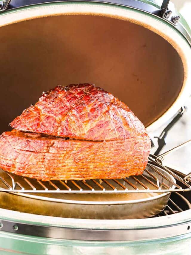 A double smoked ham on a outdoor smoker ready to eat.