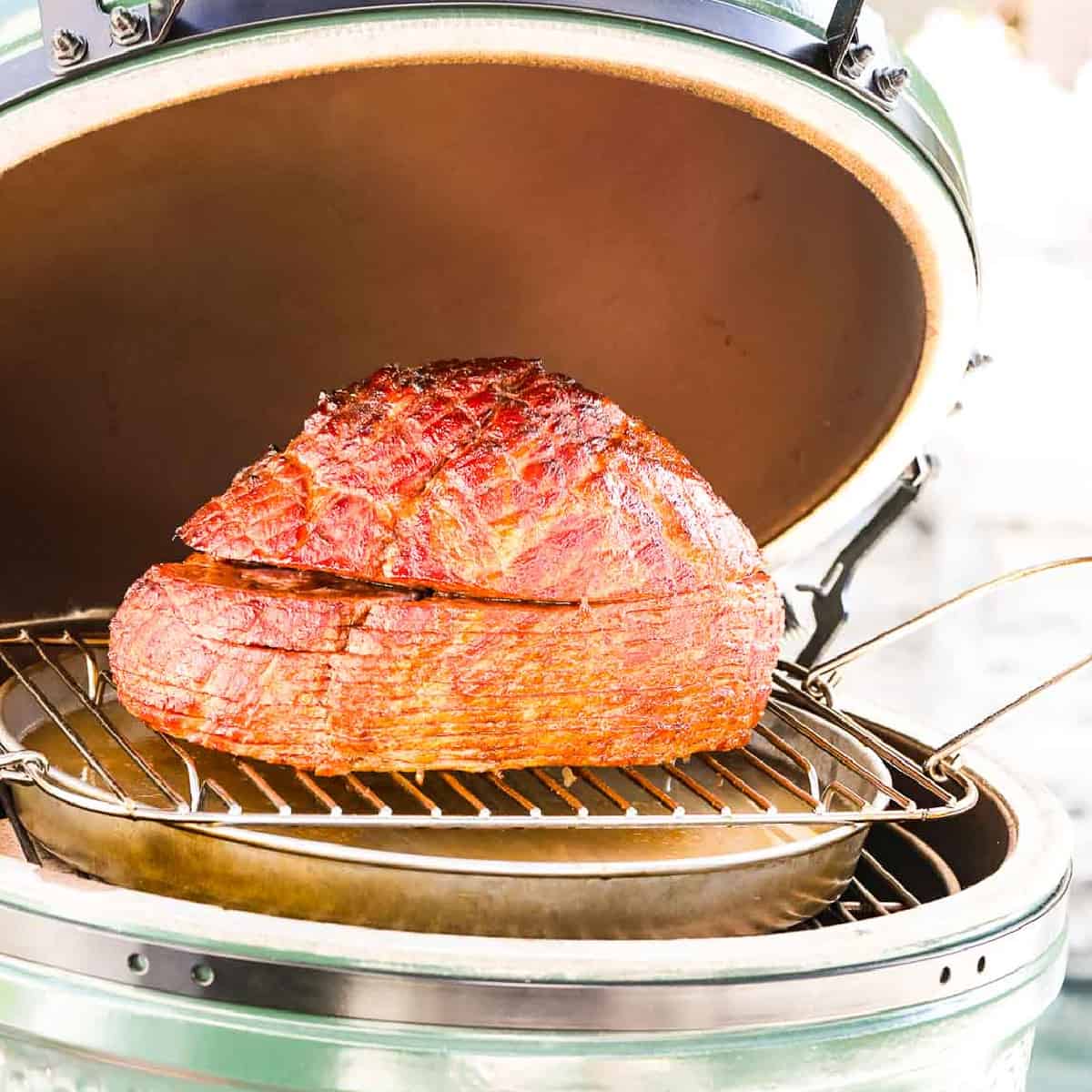 A double smoked ham on a outdoor smoker ready to eat.