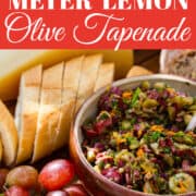 A recipe for fresh homemade olive tapenade using different olives and herbs garnished with lemon slices and flat leaf parsley.