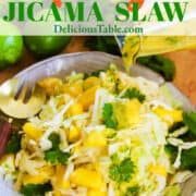 An ad for mango slaw with a plate piled high and a gold fork with dressing pouring on top.