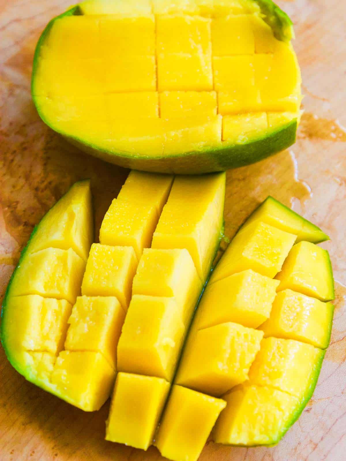 A perfectly cut open mango with cubes cut into the fruit.